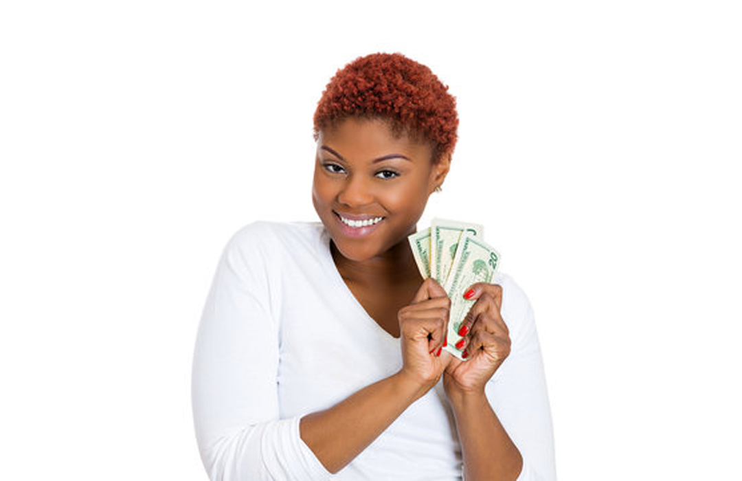 Happy woman holding cash after getting affordable house financing